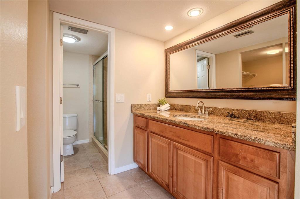 3300 South Beneva Road, Unit 214 Sarasota, FL 34232 - Photo 10 of 22 a bathroom with a granite countertop sink and a mirror