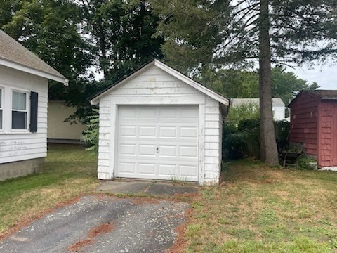 15 Howard Street Wakefield, MA 01880 - Photo 6 of 23 a front view of a house with a yard and garage