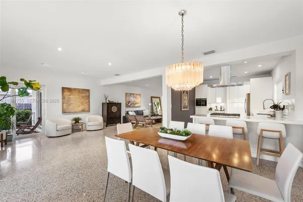 a kitchen with stainless steel appliances kitchen island a stove a sink and a refrigerator