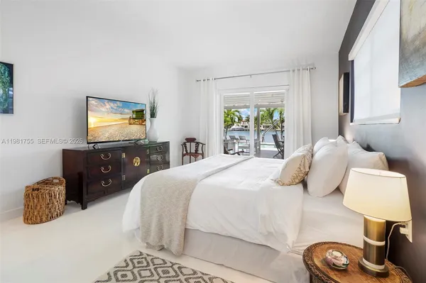 a bedroom with a bed and a lamp