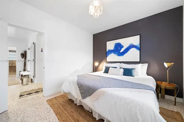 a bedroom with bed and a window