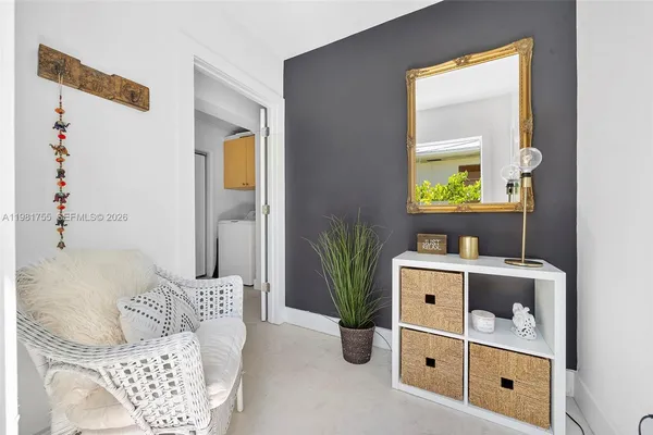 a bedroom with a bed a chandelier and dresser