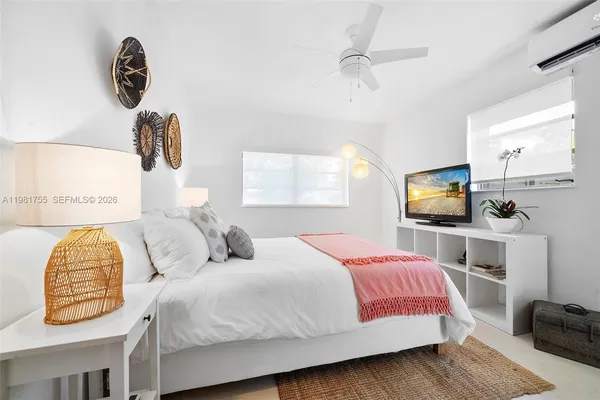 a bedroom with a bed and a flat screen tv