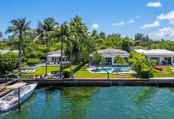 a backyard of a house with outdoor seating