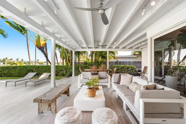 a living room with patio furniture and a large window