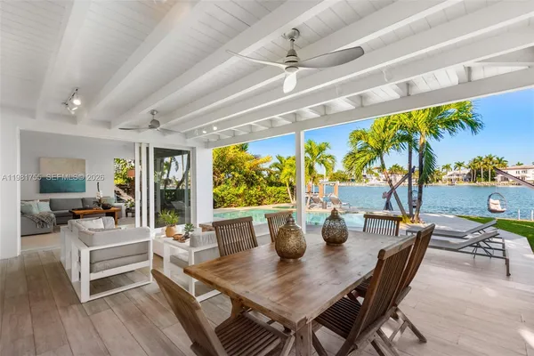 a view of a dining room with furniture large windows and wooden floor