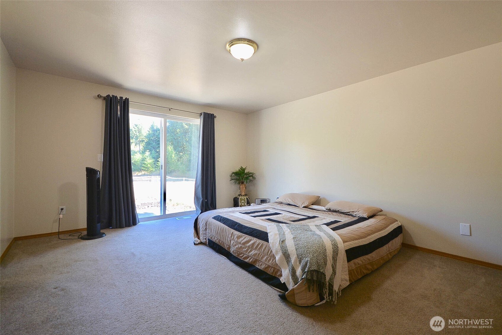 14638 Lawrence Lake Road Southeast Yelm, WA 98597 - Photo 12 of 38 a bed sitting in a spacious bedroom next to a window