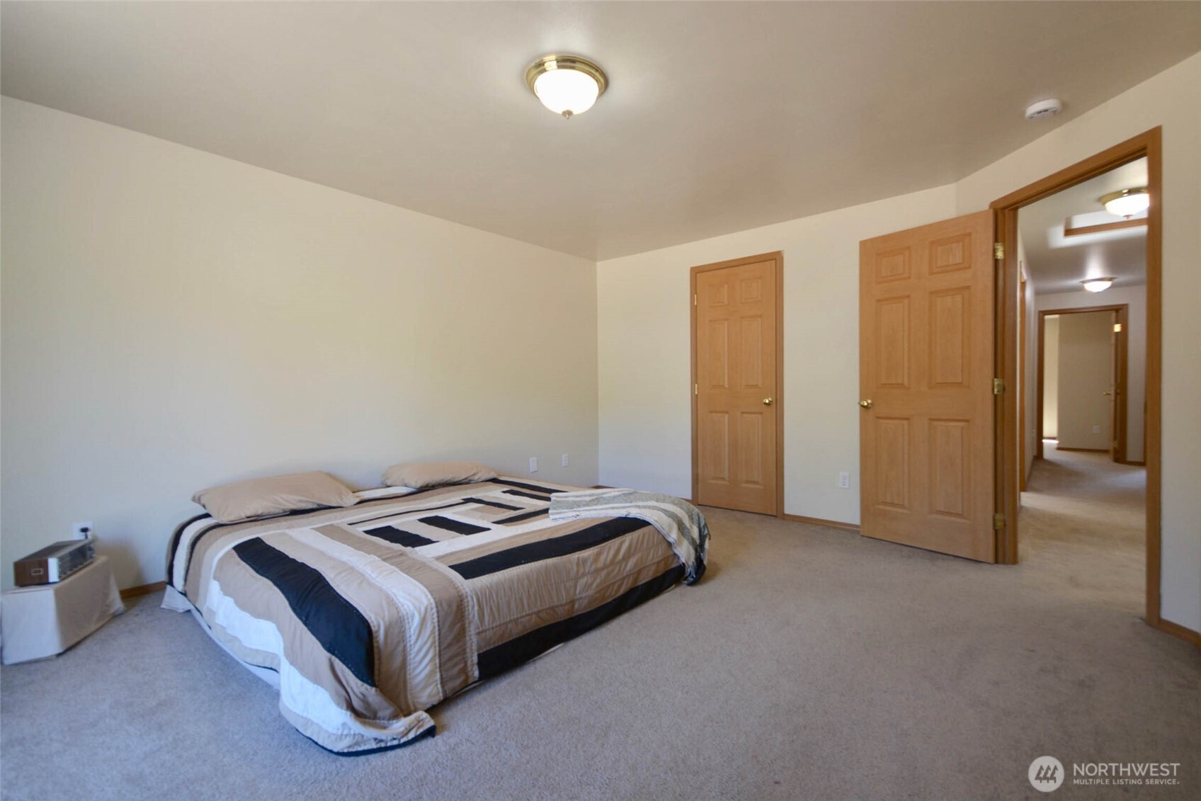 14638 Lawrence Lake Road Southeast Yelm, WA 98597 - Photo 13 of 38 a bedroom with a bed and cabinets