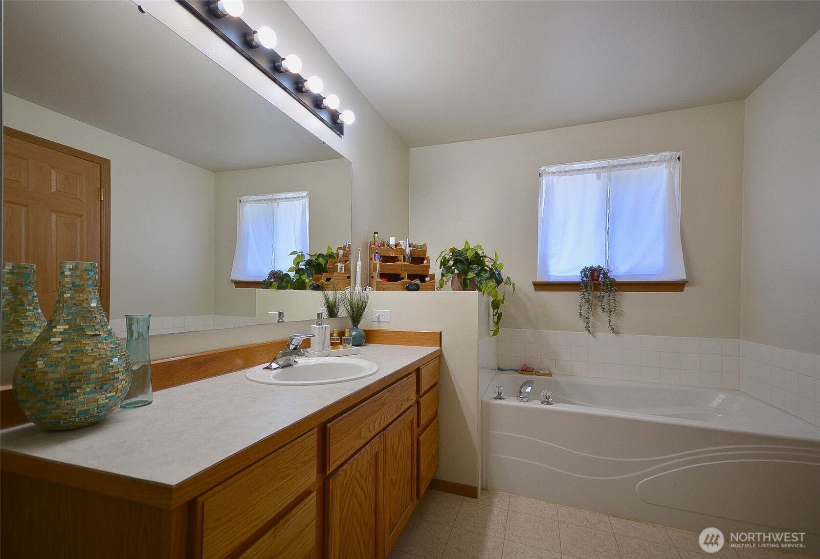 14638 Lawrence Lake Road Southeast Yelm, WA 98597 - Photo 15 of 38 a bathroom with a sink and a mirror