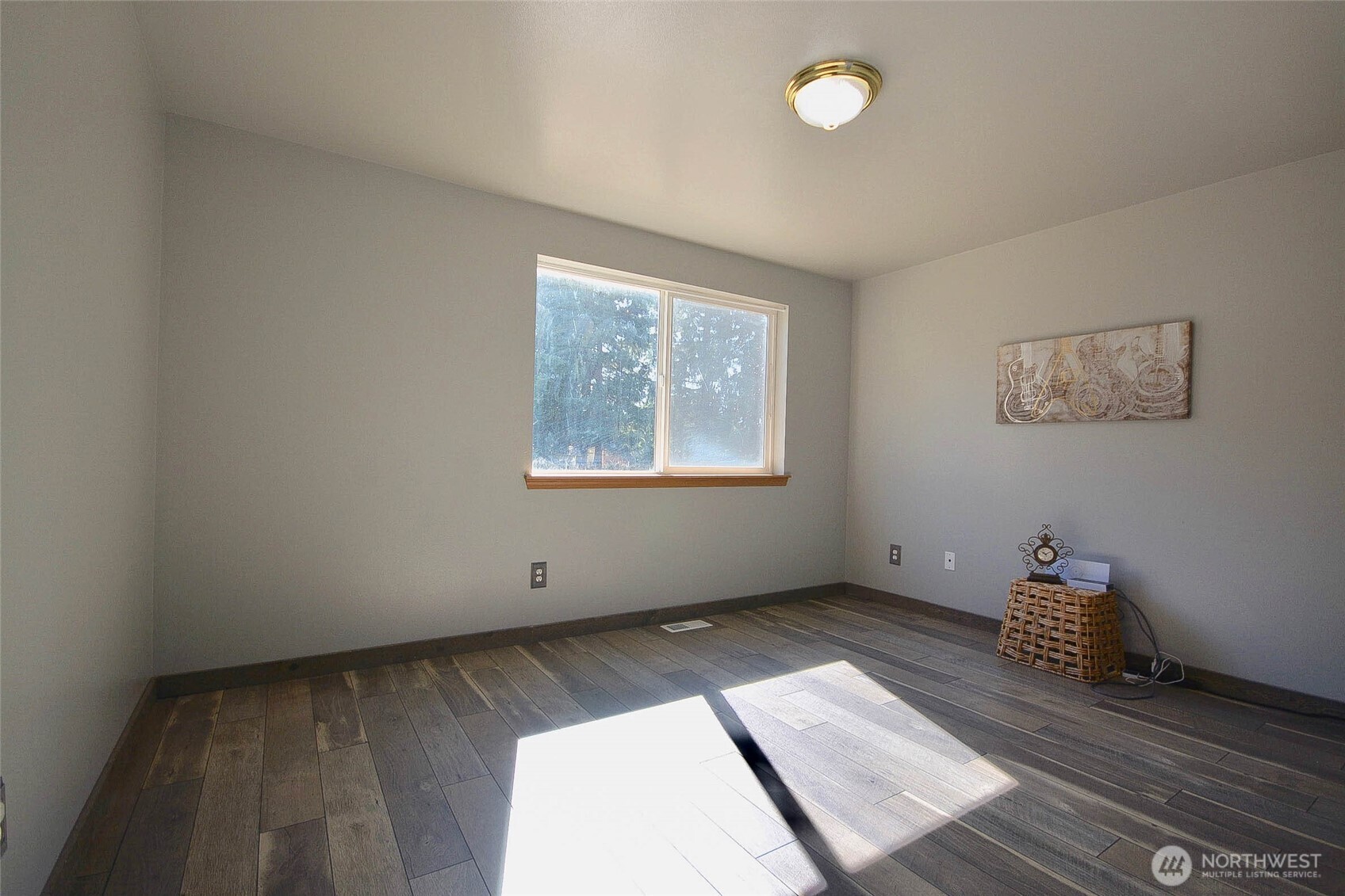 14638 Lawrence Lake Road Southeast Yelm, WA 98597 - Photo 18 of 38 an empty room with wooden floor and windows