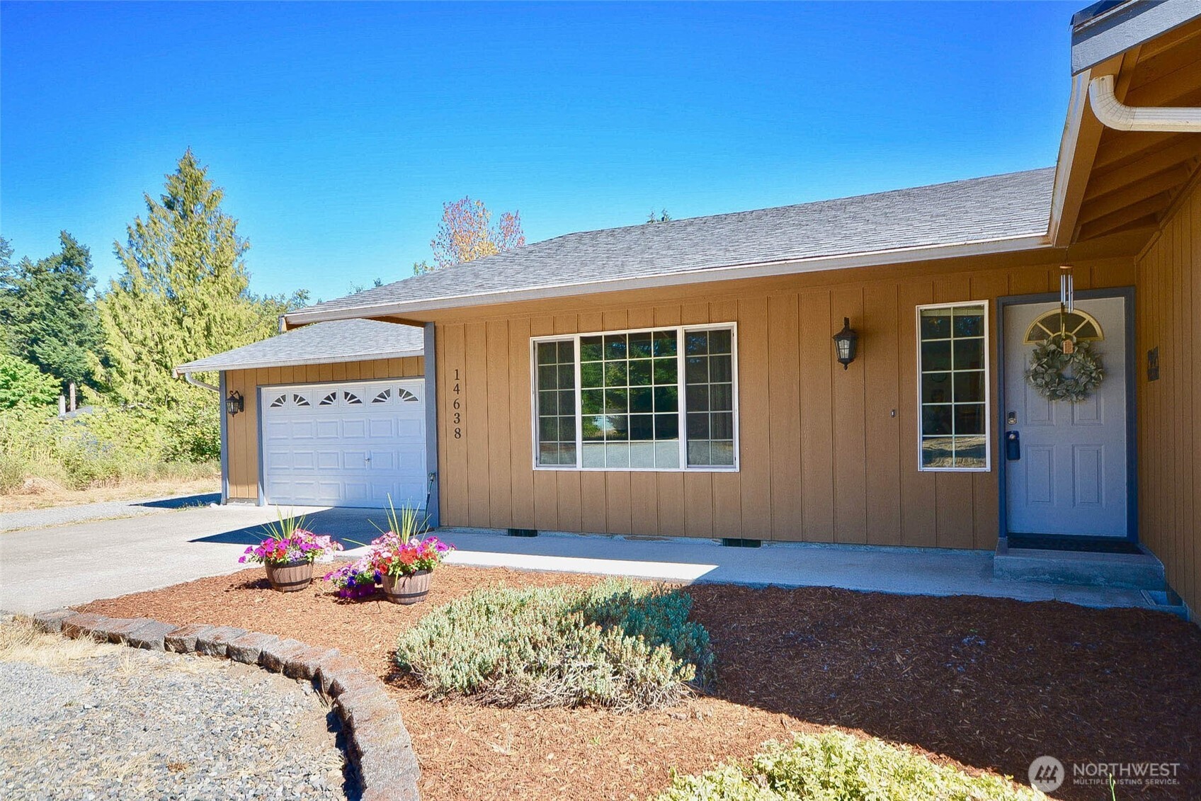 14638 Lawrence Lake Road Southeast Yelm, WA 98597 - Photo 2 of 38 a front view of a house with garden