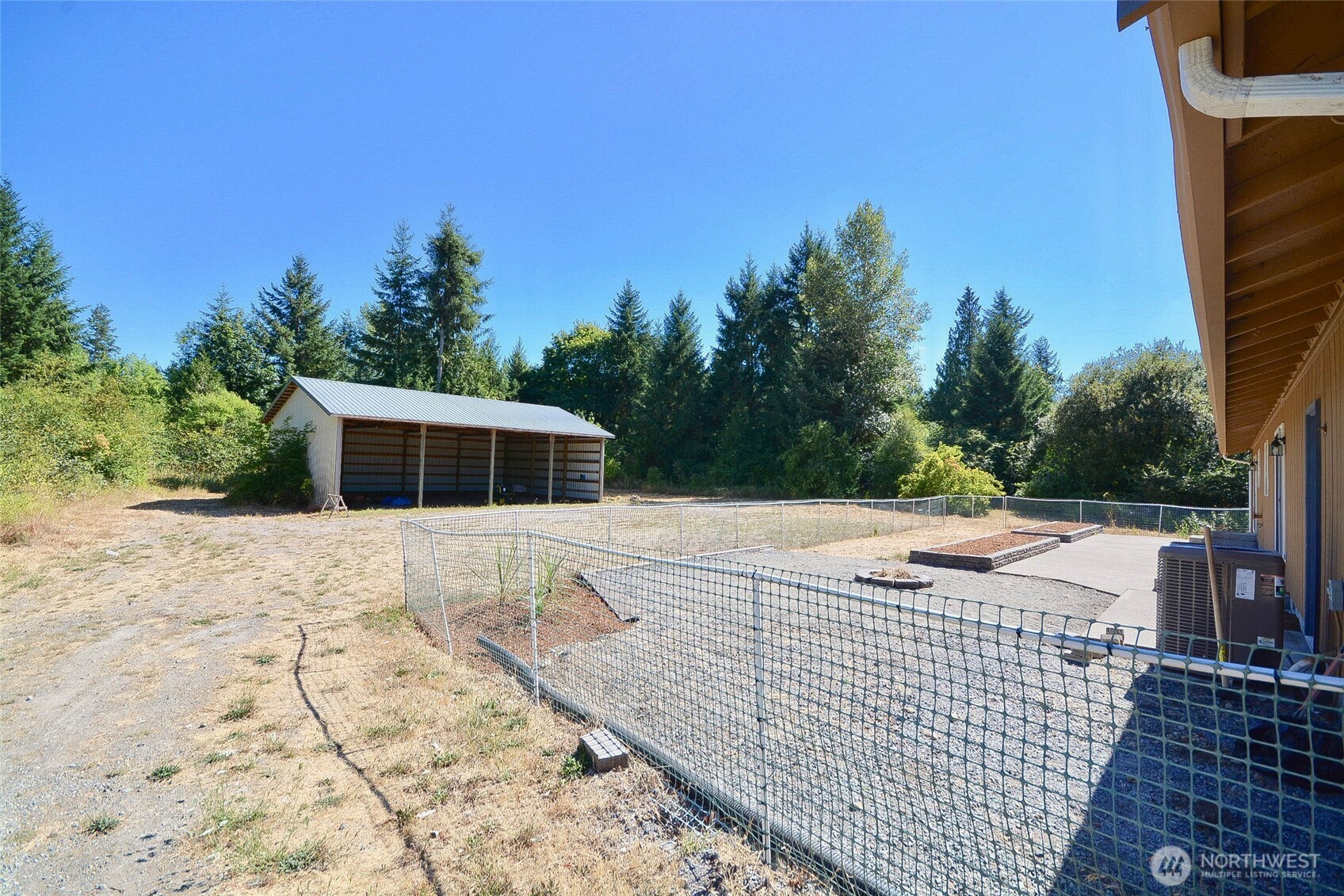 14638 Lawrence Lake Road Southeast Yelm, WA 98597 - Photo 25 of 38 a view of a house with a yard