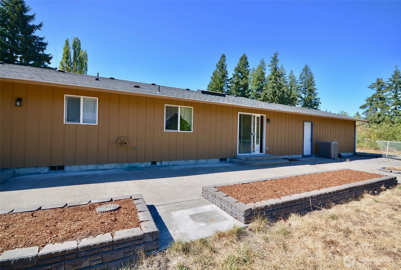 14638 Lawrence Lake Road Southeast Yelm, WA 98597 - Photo 29 of 38 a view of a house with a patio