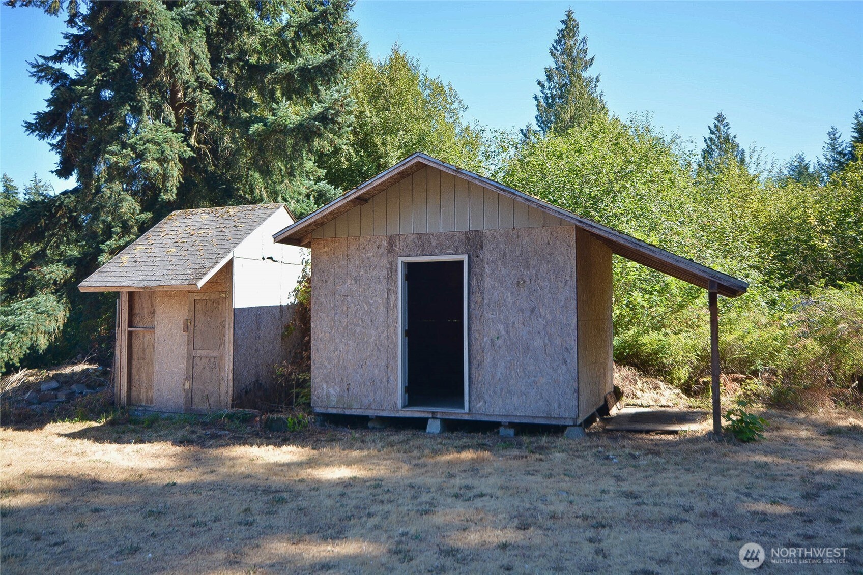 14638 Lawrence Lake Road Southeast Yelm, WA 98597 - Photo 32 of 38 a backyard of a house with large trees and wooden fence