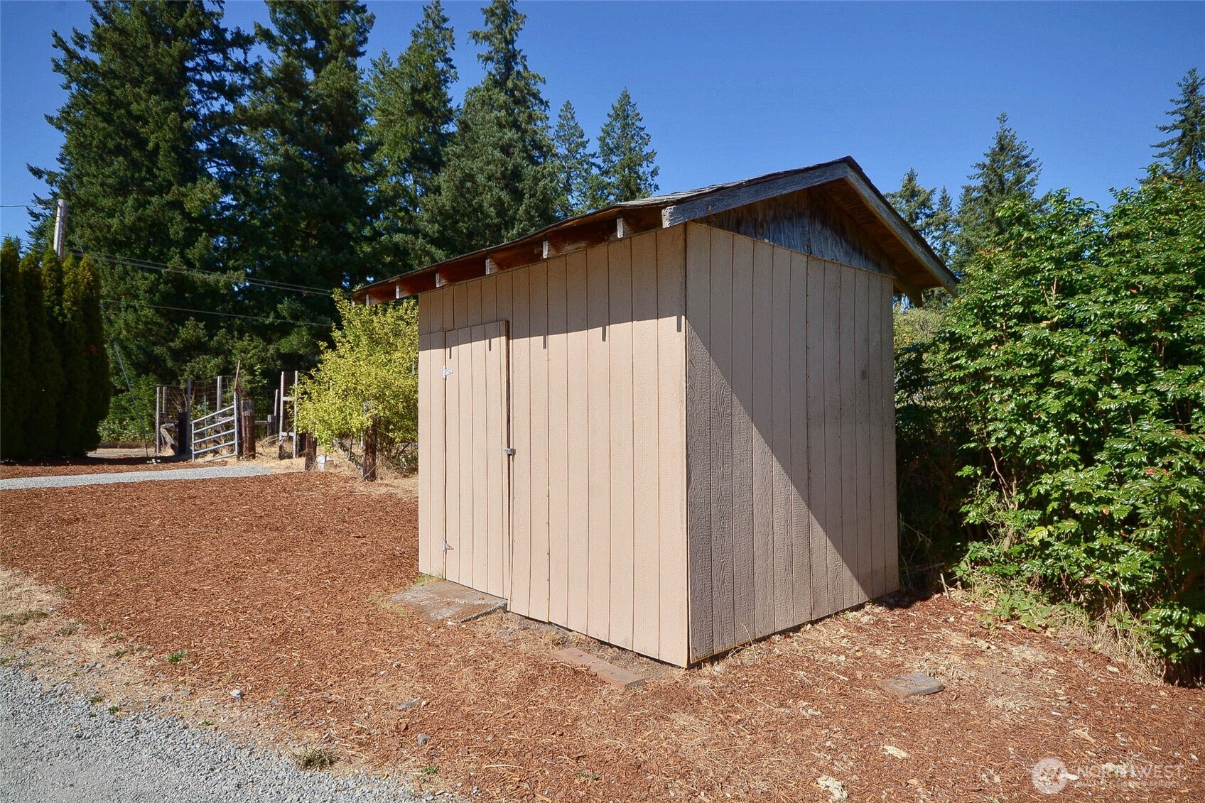 14638 Lawrence Lake Road Southeast Yelm, WA 98597 - Photo 33 of 38 a backyard of a house with plants and trees