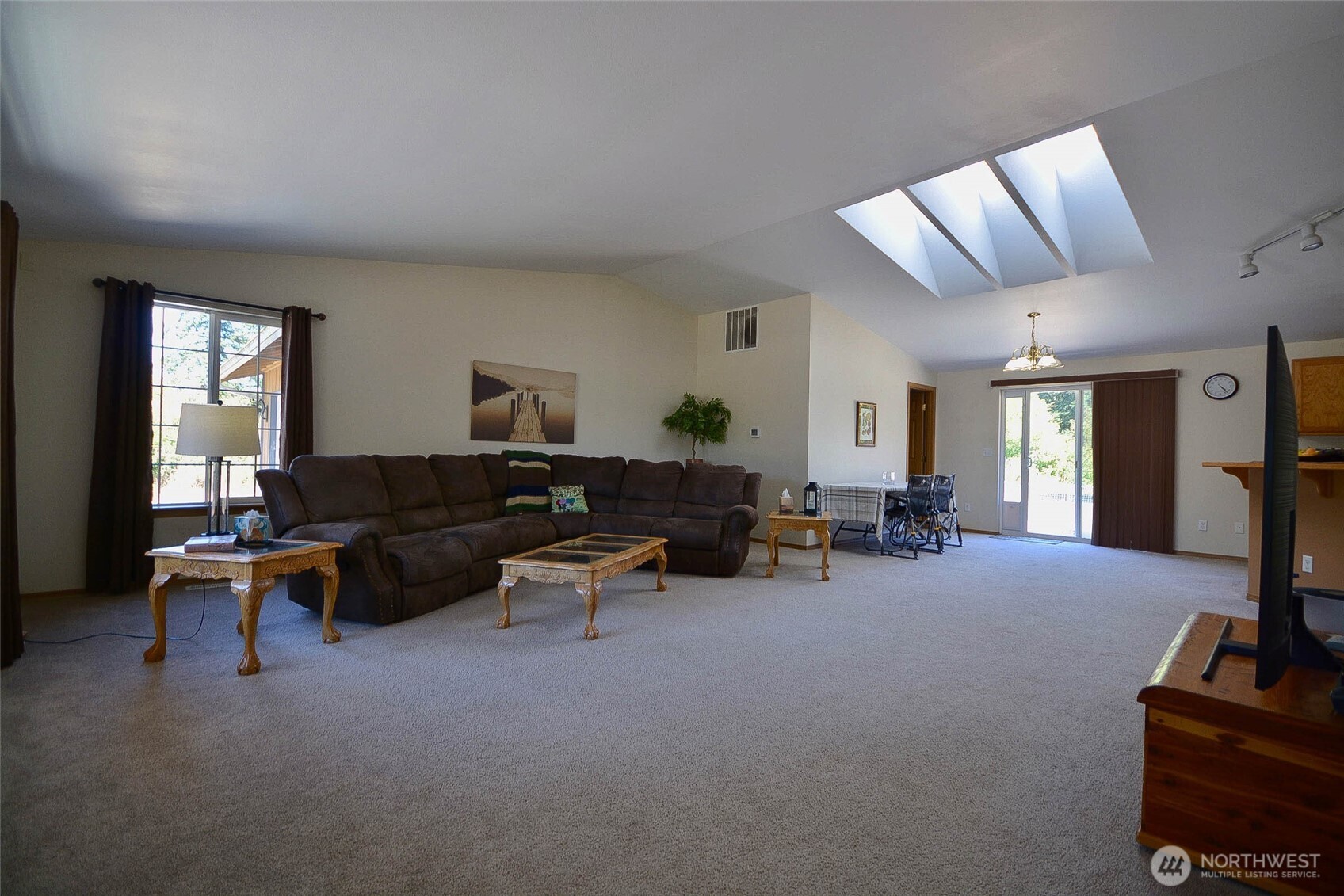 14638 Lawrence Lake Road Southeast Yelm, WA 98597 - Photo 5 of 38 a living room with furniture and a flat screen tv