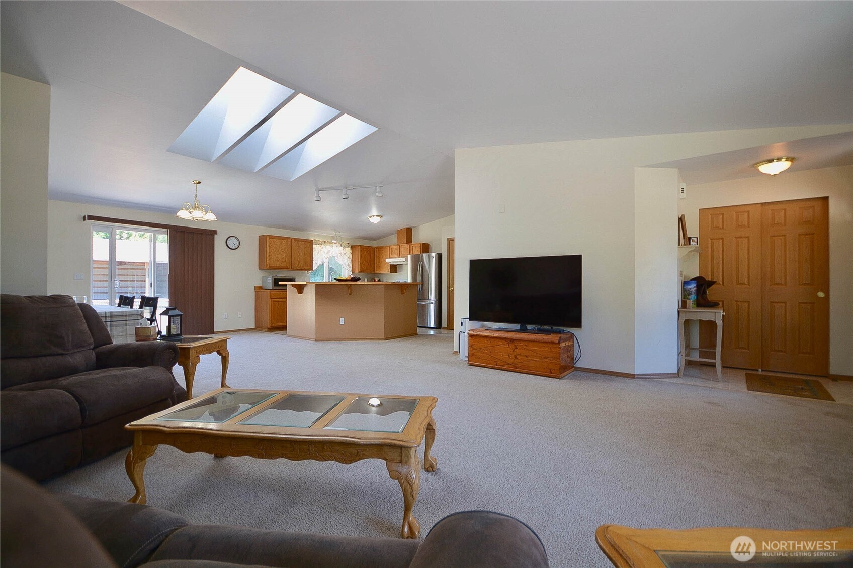 14638 Lawrence Lake Road Southeast Yelm, WA 98597 - Photo 6 of 38 a living room with furniture and a flat screen tv