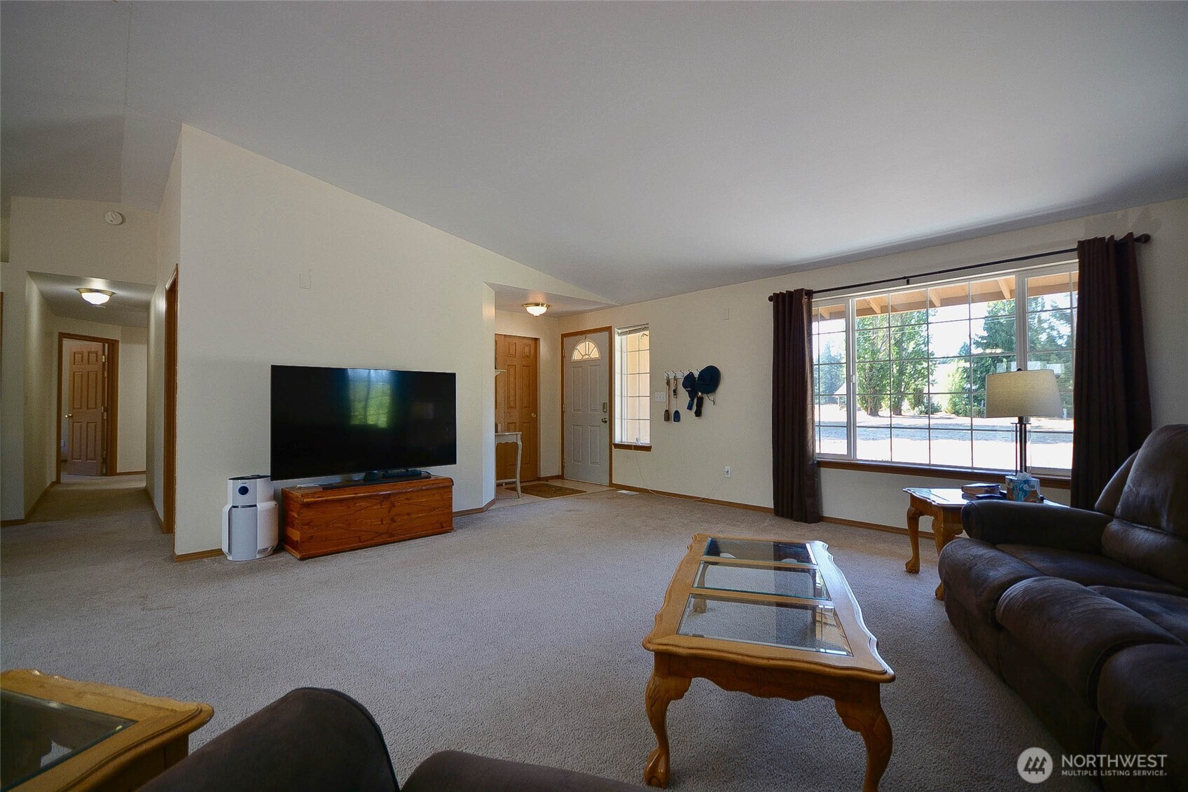 14638 Lawrence Lake Road Southeast Yelm, WA 98597 - Photo 7 of 38 a living room with furniture and a flat screen tv