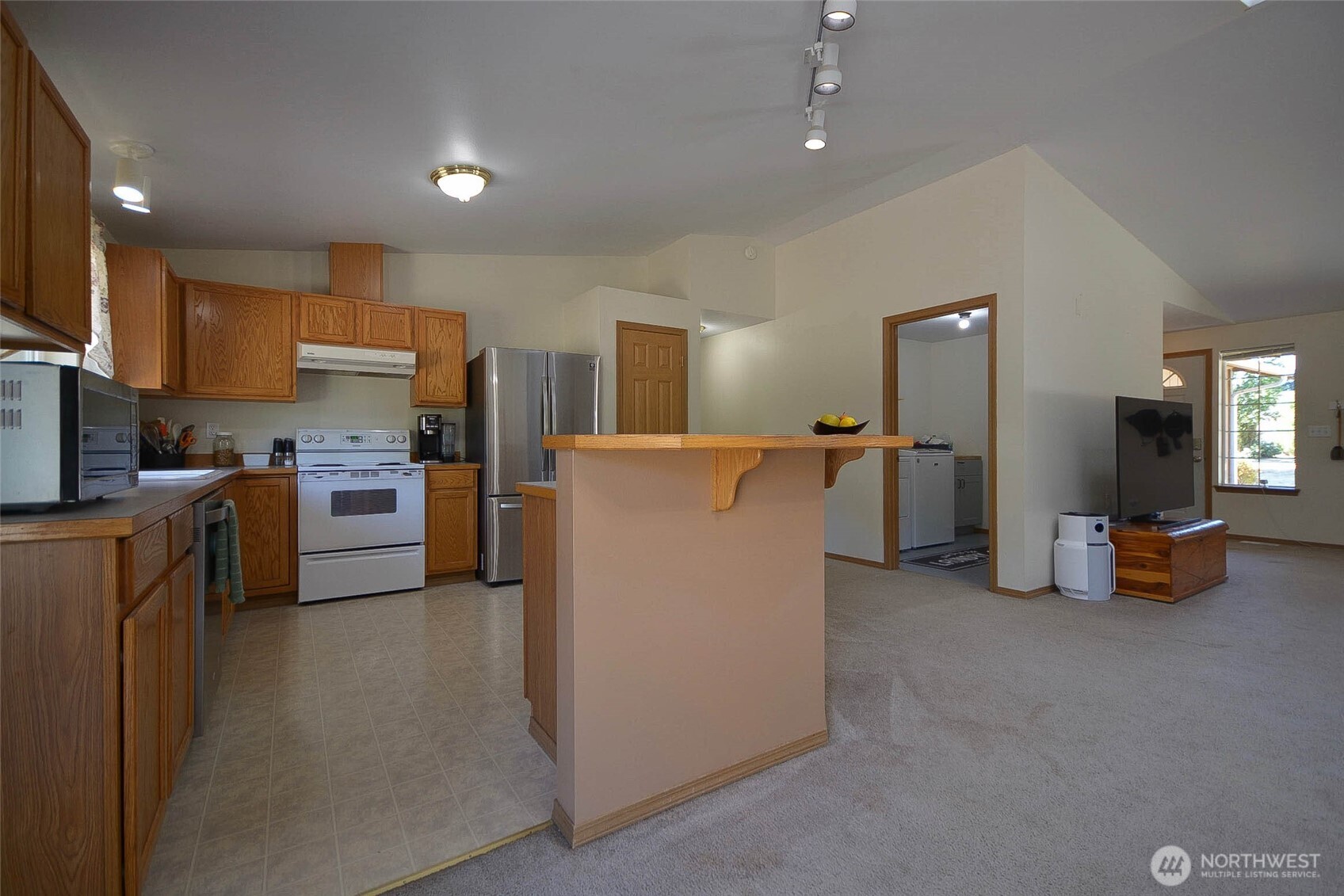 14638 Lawrence Lake Road Southeast Yelm, WA 98597 - Photo 8 of 38 a kitchen with refrigerator and cabinets