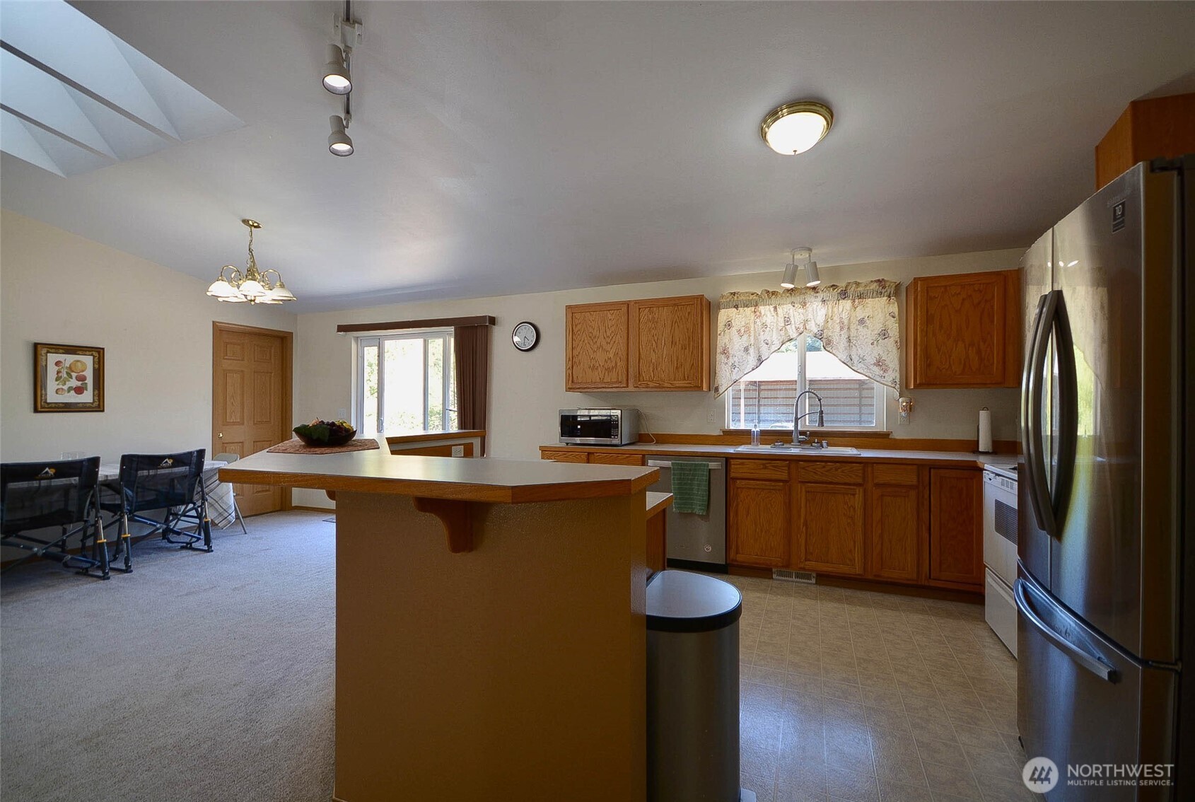 14638 Lawrence Lake Road Southeast Yelm, WA 98597 - Photo 10 of 38 a kitchen with sink cabinets and dining table