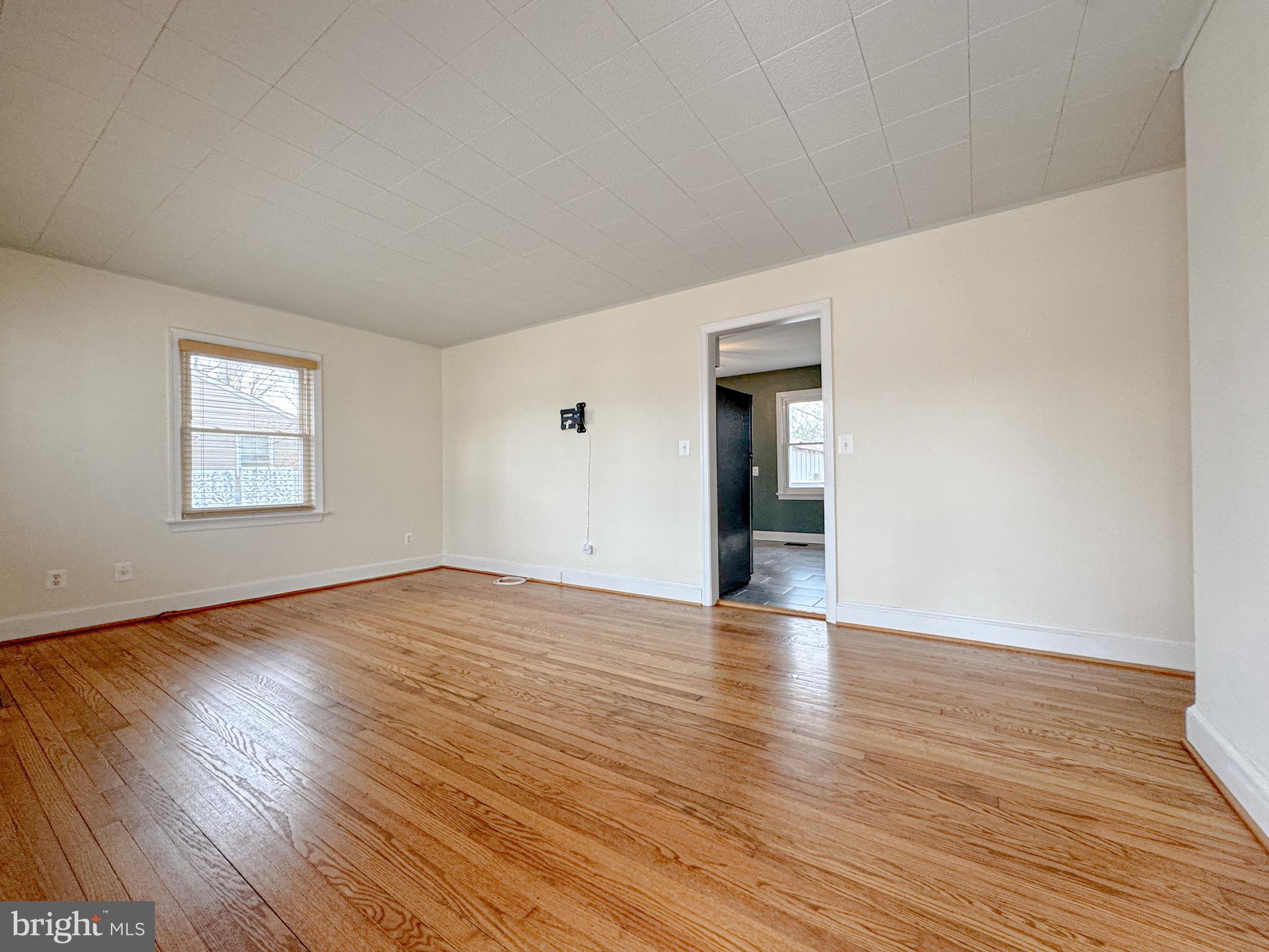 10 Blair Road Fredericksburg, VA 22405 - Photo 2 of 15 a view of an empty room with wooden floor and a window