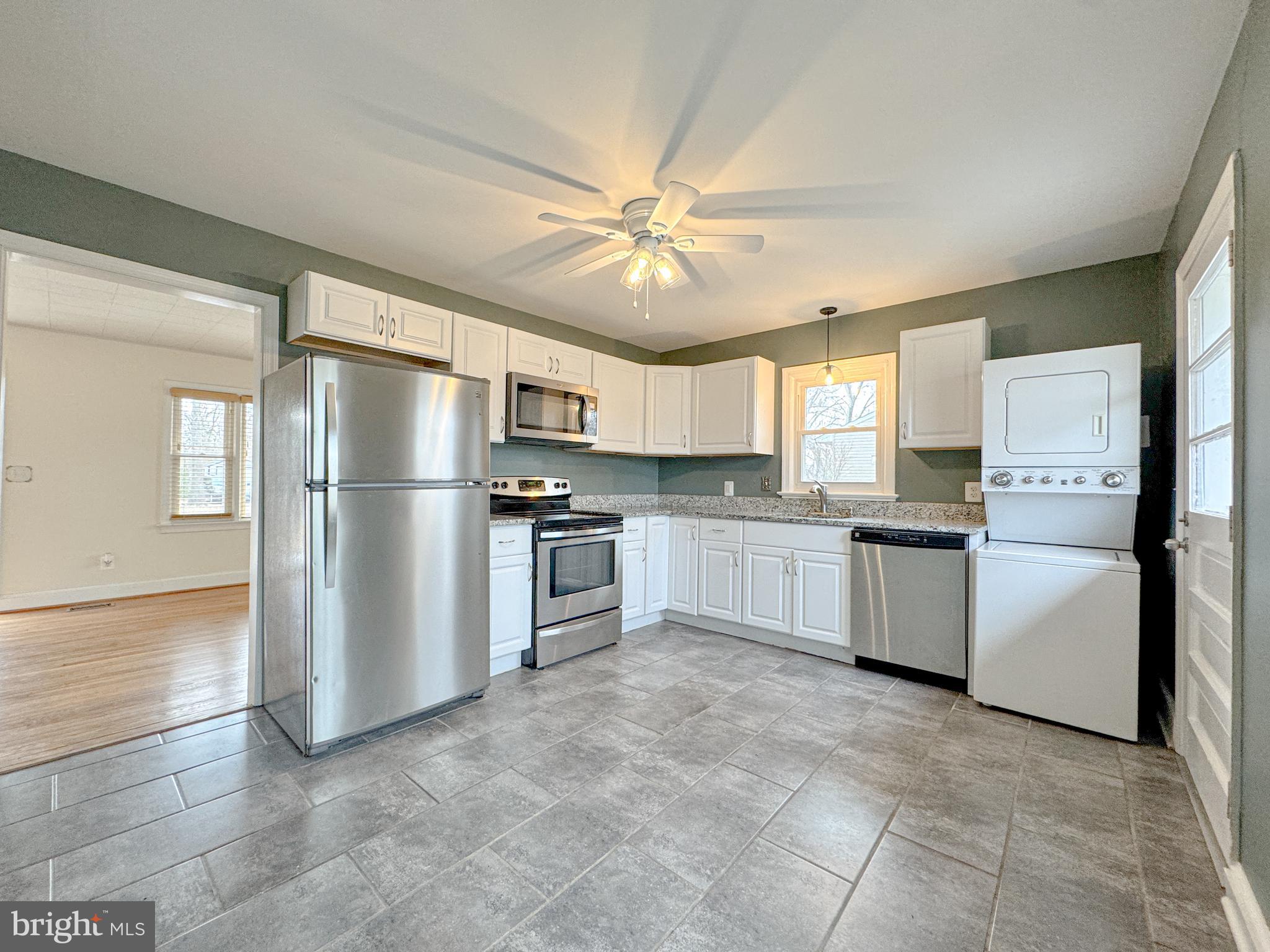 10 Blair Road Fredericksburg, VA 22405 - Photo 3 of 15 a kitchen with granite countertop a refrigerator and a sink
