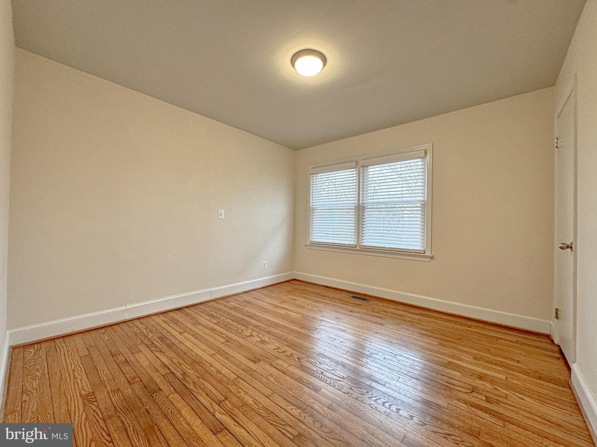 10 Blair Road Fredericksburg, VA 22405 - Photo 7 of 15 a view of an empty room with wooden floor and a window