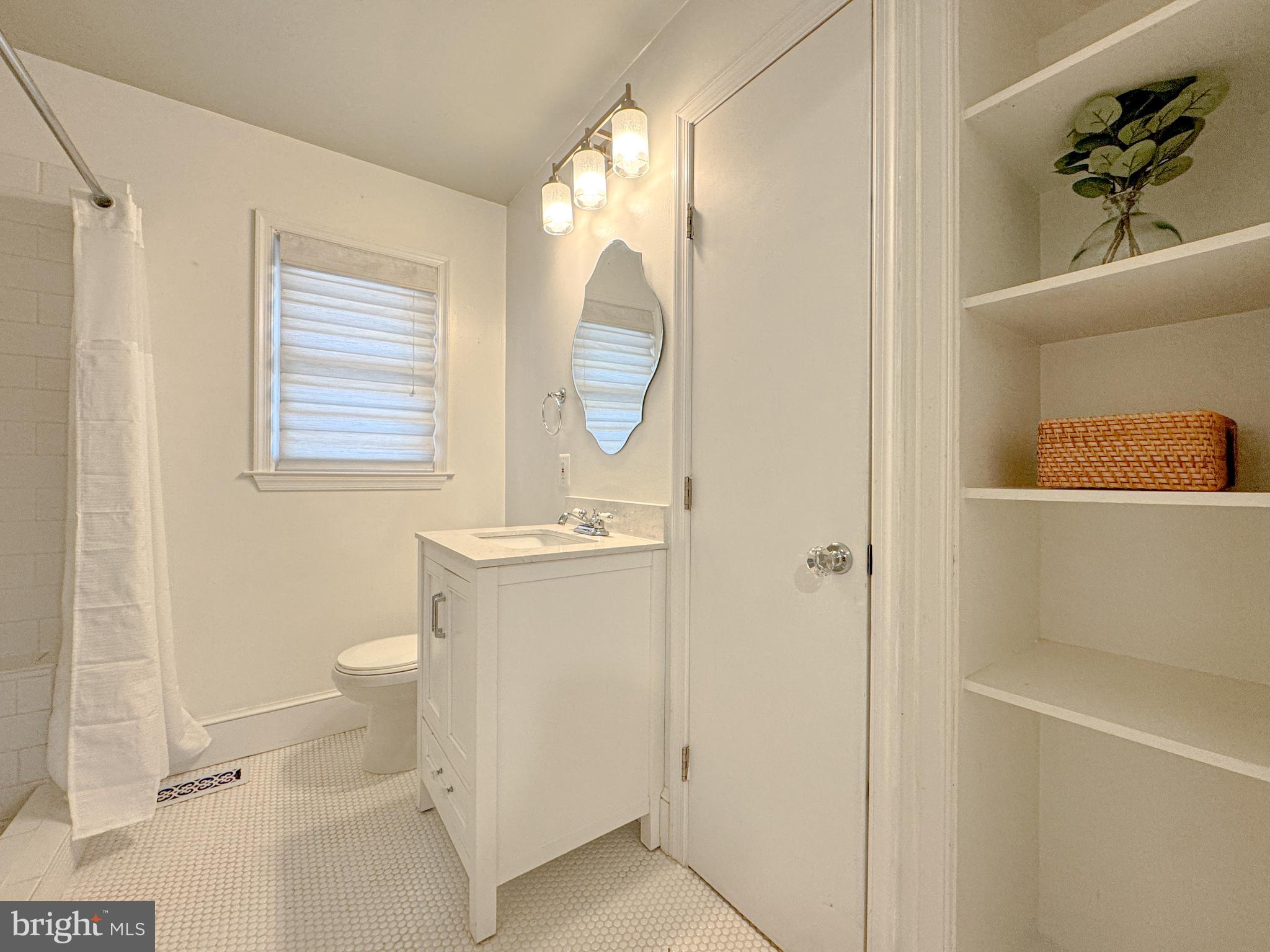 10 Blair Road Fredericksburg, VA 22405 - Photo 8 of 15 a bathroom with a sink a toilet and a mirror