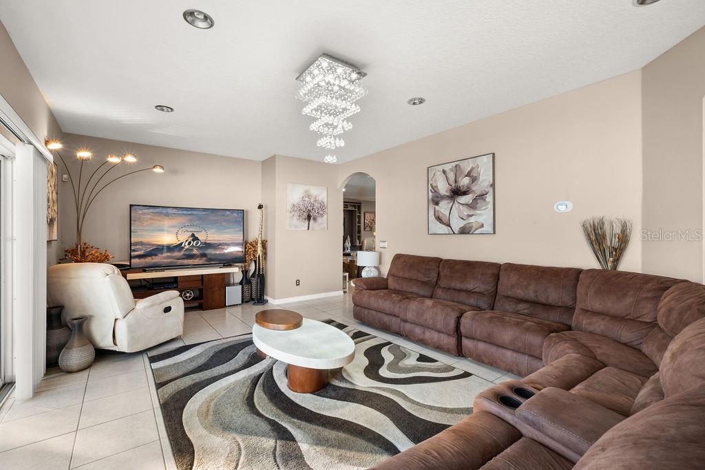 1349 Castleport Road Winter Garden, FL 34787 - Photo 11 of 40 a living room with furniture and a chandelier