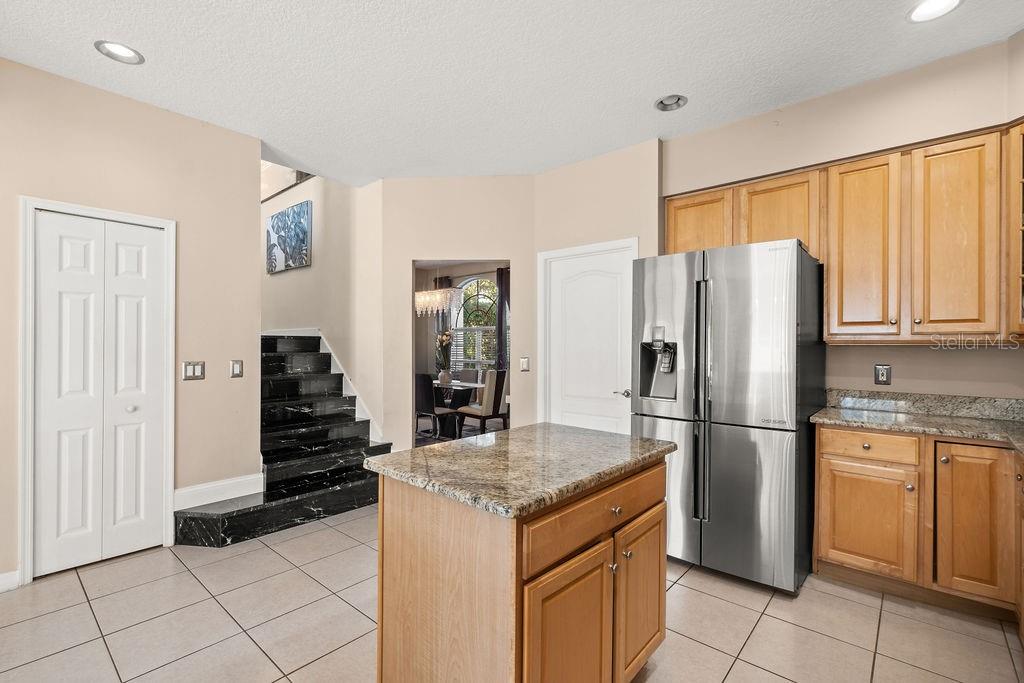 1349 Castleport Road Winter Garden, FL 34787 - Photo 15 of 40 a kitchen with stainless steel appliances granite countertop a refrigerator and a stove top oven