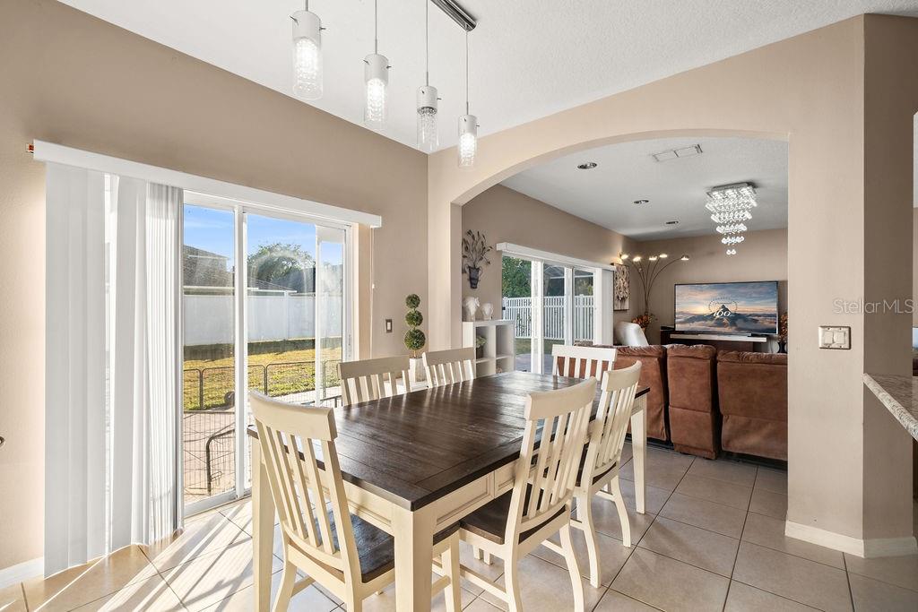 1349 Castleport Road Winter Garden, FL 34787 - Photo 17 of 40 a dining room with stainless steel appliances granite countertop a dining table and chairs