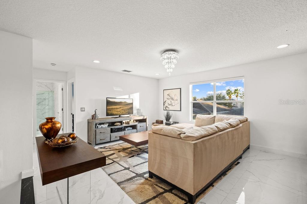 1349 Castleport Road Winter Garden, FL 34787 - Photo 26 of 40 a living room with furniture and a flat screen tv