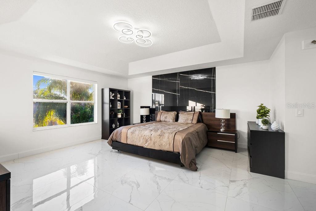 1349 Castleport Road Winter Garden, FL 34787 - Photo 27 of 40 a bedroom with a large bed and a window