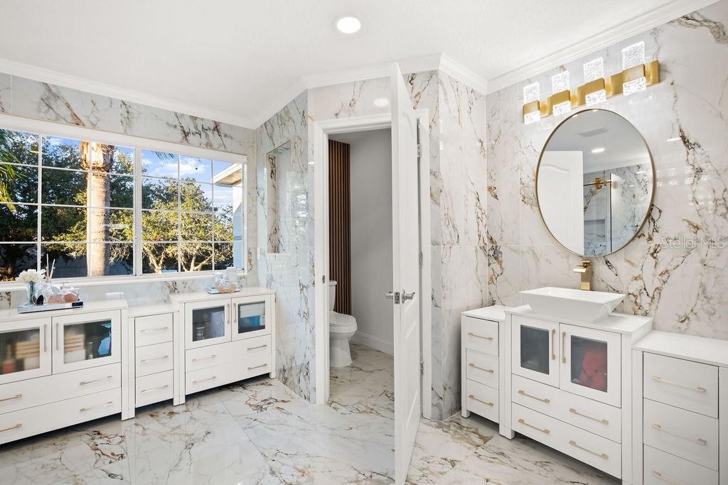 1349 Castleport Road Winter Garden, FL 34787 - Photo 30 of 40 a bathroom with a double vanity sink and mirror