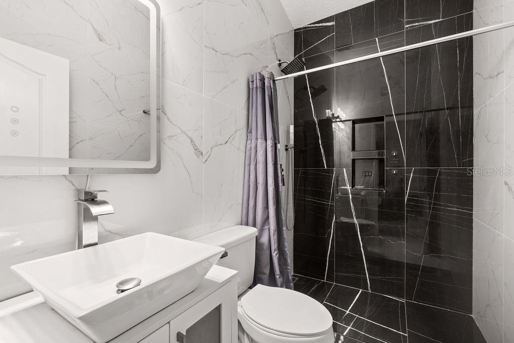 1349 Castleport Road Winter Garden, FL 34787 - Photo 35 of 40 a bathroom with a toilet a sink and shower