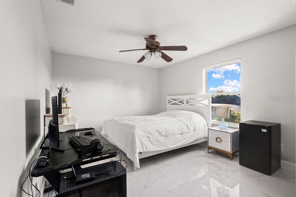 1349 Castleport Road Winter Garden, FL 34787 - Photo 37 of 40 a bedroom with a bed and a ceiling fan