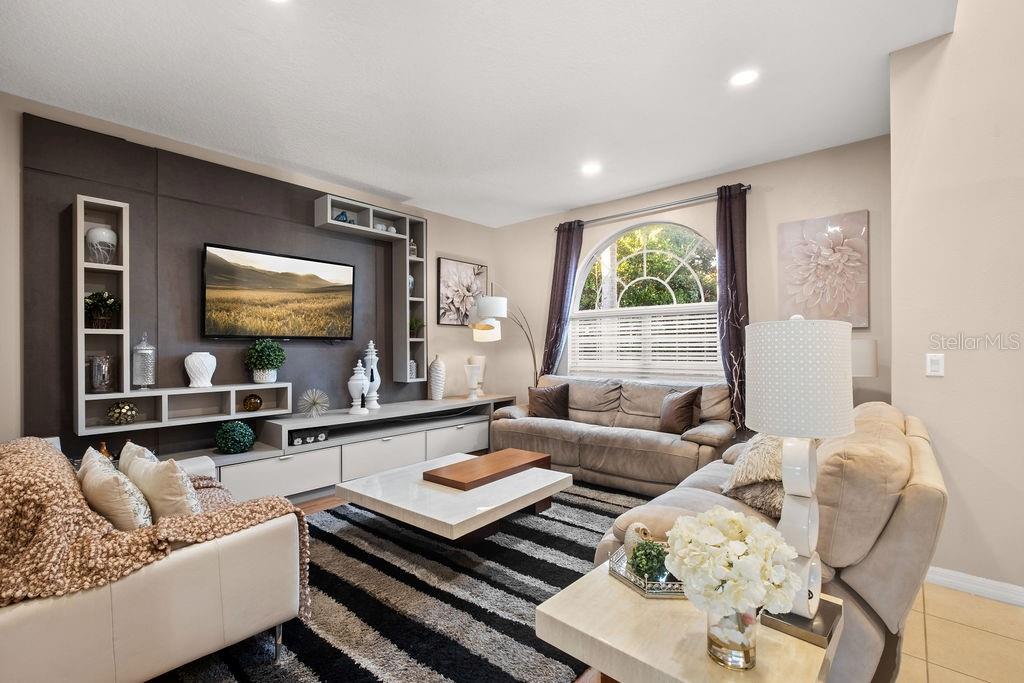 1349 Castleport Road Winter Garden, FL 34787 - Photo 6 of 40 a living room with furniture and a flat screen tv