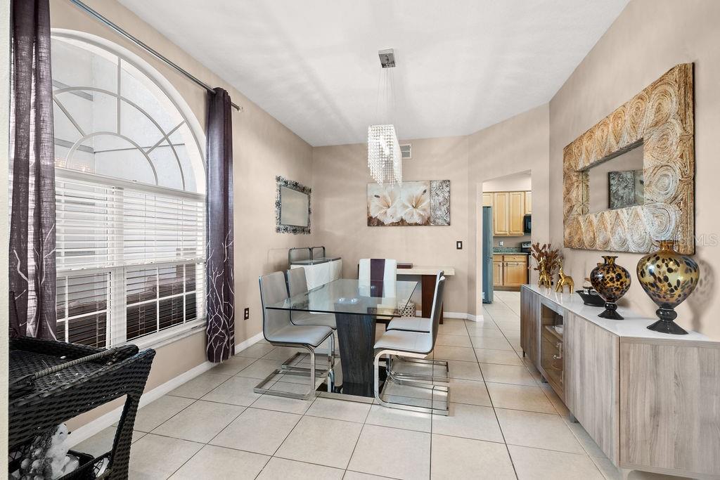 1349 Castleport Road Winter Garden, FL 34787 - Photo 8 of 40 a view of a dining room with furniture a chandelier and wooden floor