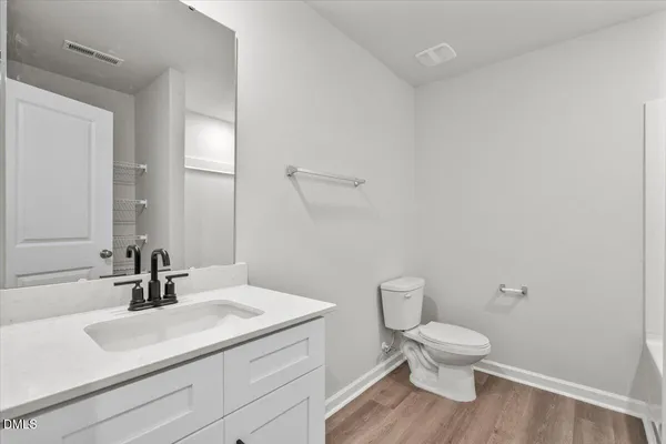 a bathroom with a sink toilet and mirror
