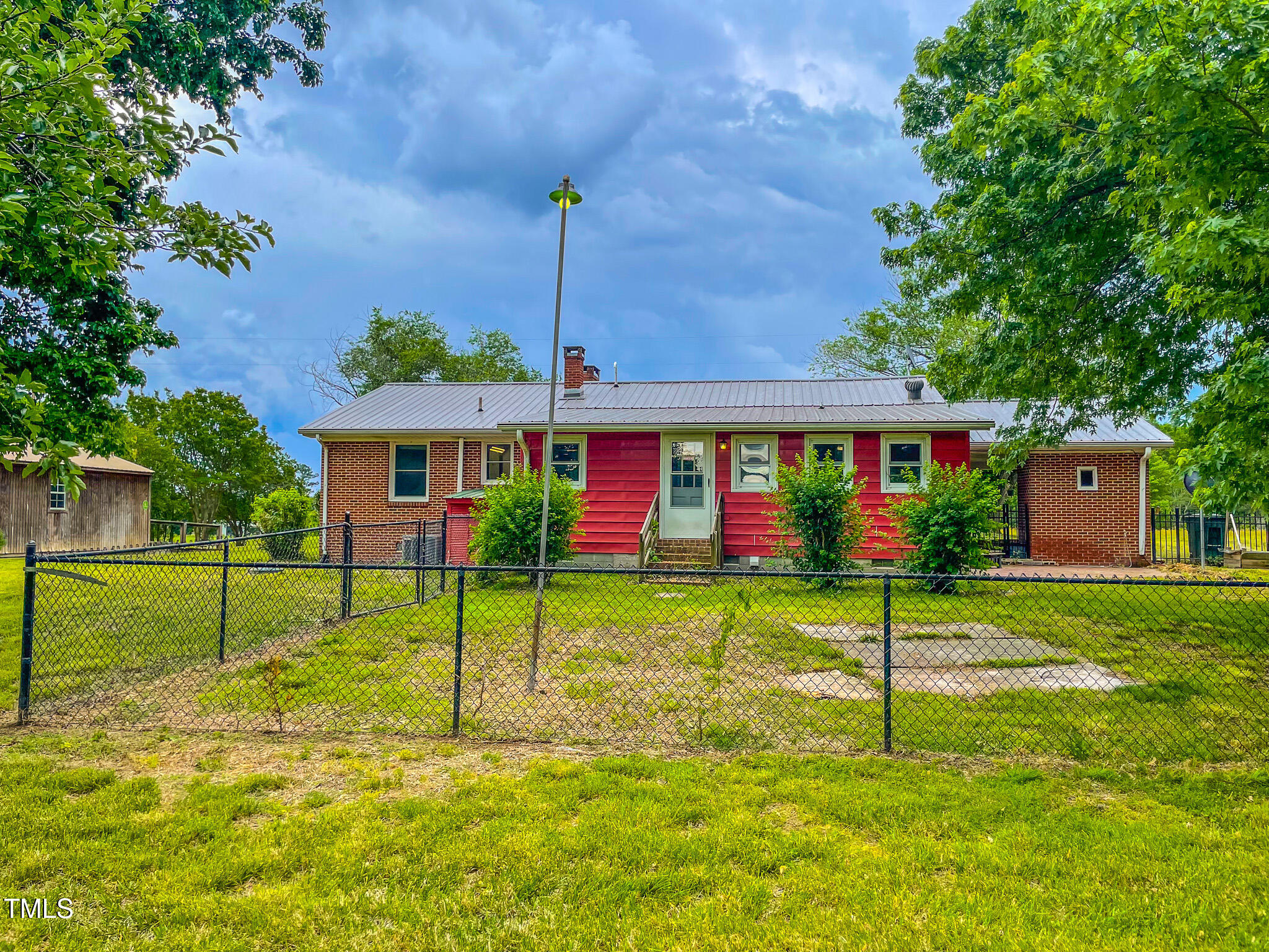 623 Chambers Road Rougemont, NC 27572 - Photo 11 of 44 a front view of a house with plants and porch