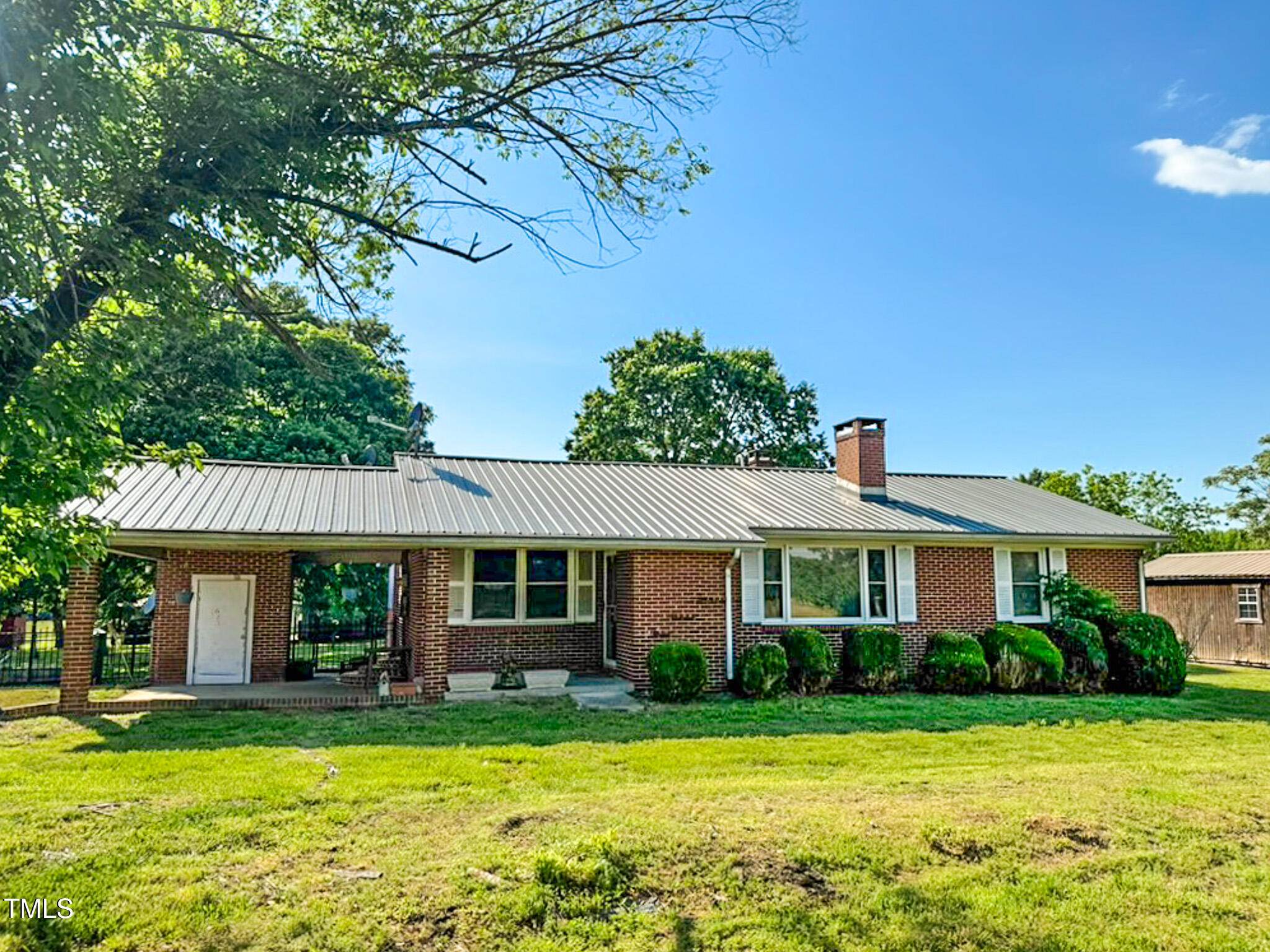 623 Chambers Road Rougemont, NC 27572 - Photo 2 of 44 a front view of a house with a garden and porch