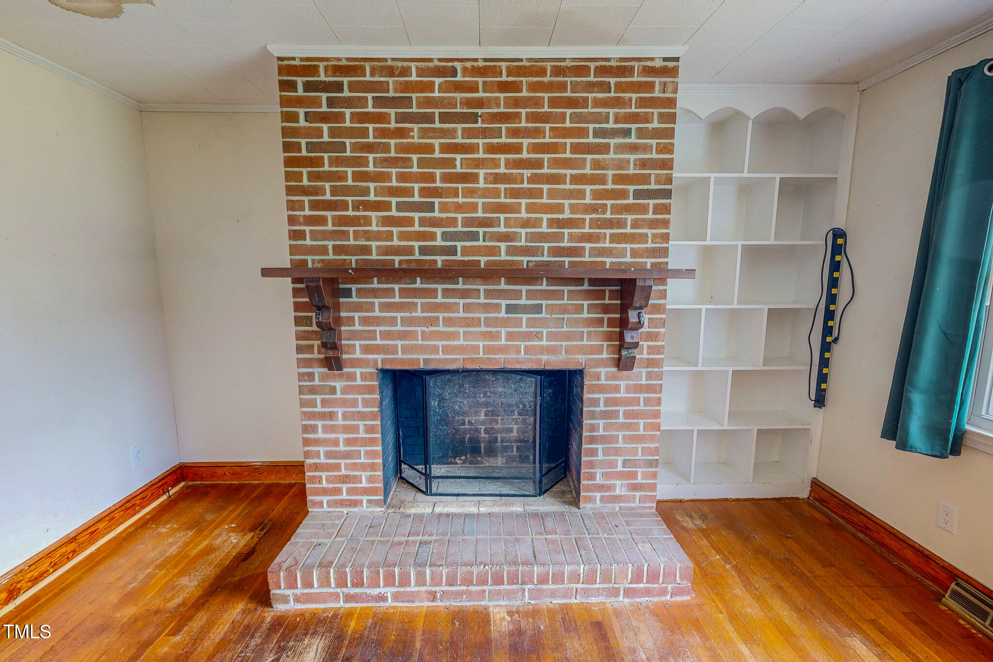 623 Chambers Road Rougemont, NC 27572 - Photo 26 of 44 a view of empty room with wooden floor and fireplace