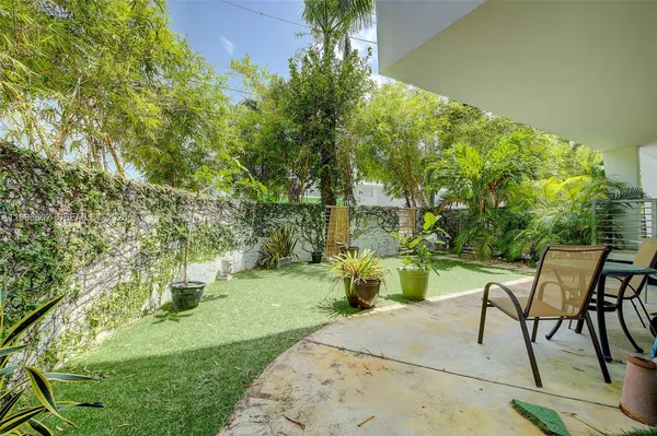 a view of a backyard with sitting area