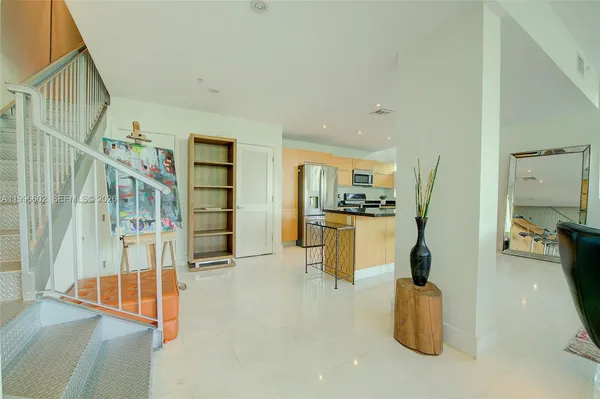 a view of living room filled with furniture and window