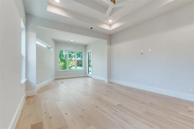 a bedroom with a large bed and windows