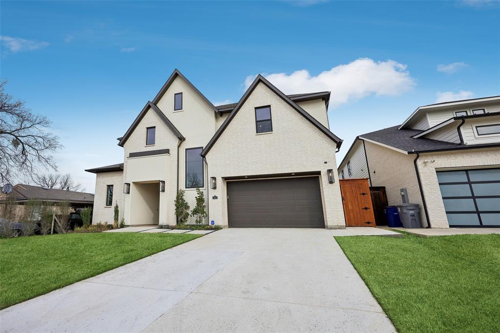 3845 Van Ness Lane Dallas, TX 75220 - Photo 30 of 33 View of front facade with a gate, driveway, an attached garage, and brick siding