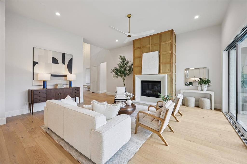 3845 Van Ness Lane Dallas, TX 75220 - Photo 7 of 33 Living room featuring a ceiling fan, light wood finished floors, a large fireplace, and recessed lighting