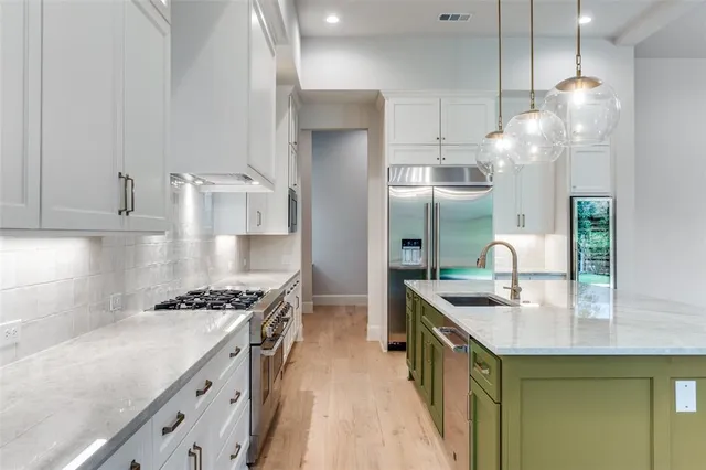 a kitchen with granite countertop a sink stove and cabinets