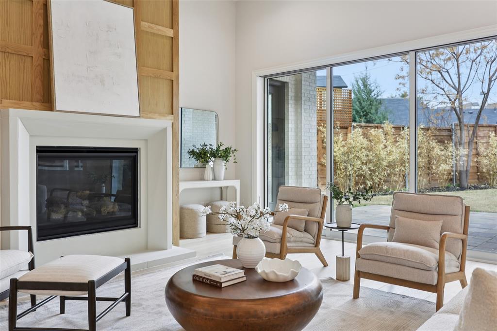 3845 Van Ness Lane Dallas, TX 75220 - Photo 9 of 33 Living area with a glass covered fireplace and wood finished floors