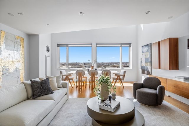 a living room with couches and a dining table with chairs